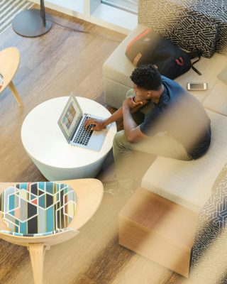 pexels-photo-1251862-1251862 Young man working remotely on laptop in a stylish modern home interior setting.